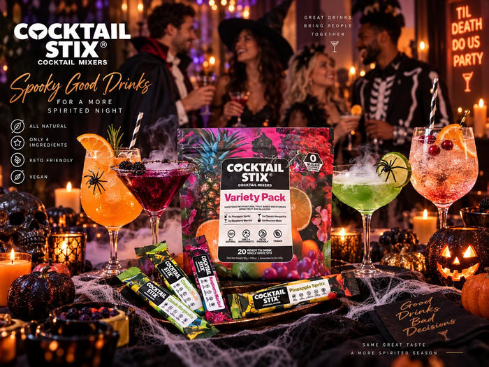 An elegant Halloween cocktail table with Raspberry Martini, Pineapple Spritz, Moscow Mule, and Classic Margarita drinks, styled with dark napkins, blackberries, citrus, and subtle candles.